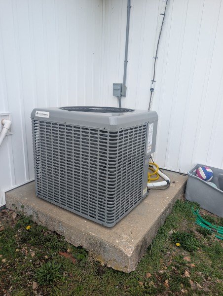 Outdoor air conditioning condenser on a concrete pad