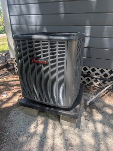 Air Heroes technicians positioning indoor HVAC equipment