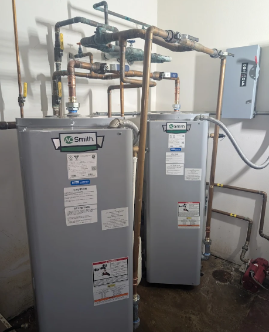 Two installed commercial water heaters and piping
